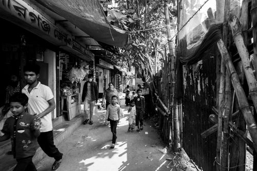 Free Black and white street scene in Dhaka, Bangladesh, featuring local residents and typical urban environment. Stock Photo