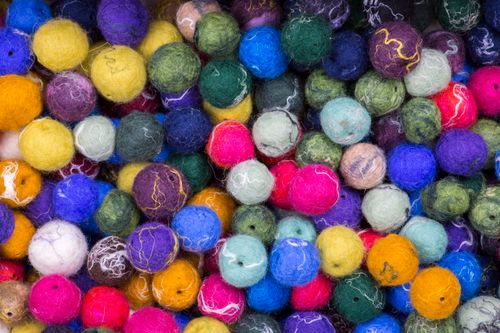 Free Vibrant collection of multicolored felt balls creating a rich textured background. Stock Photo