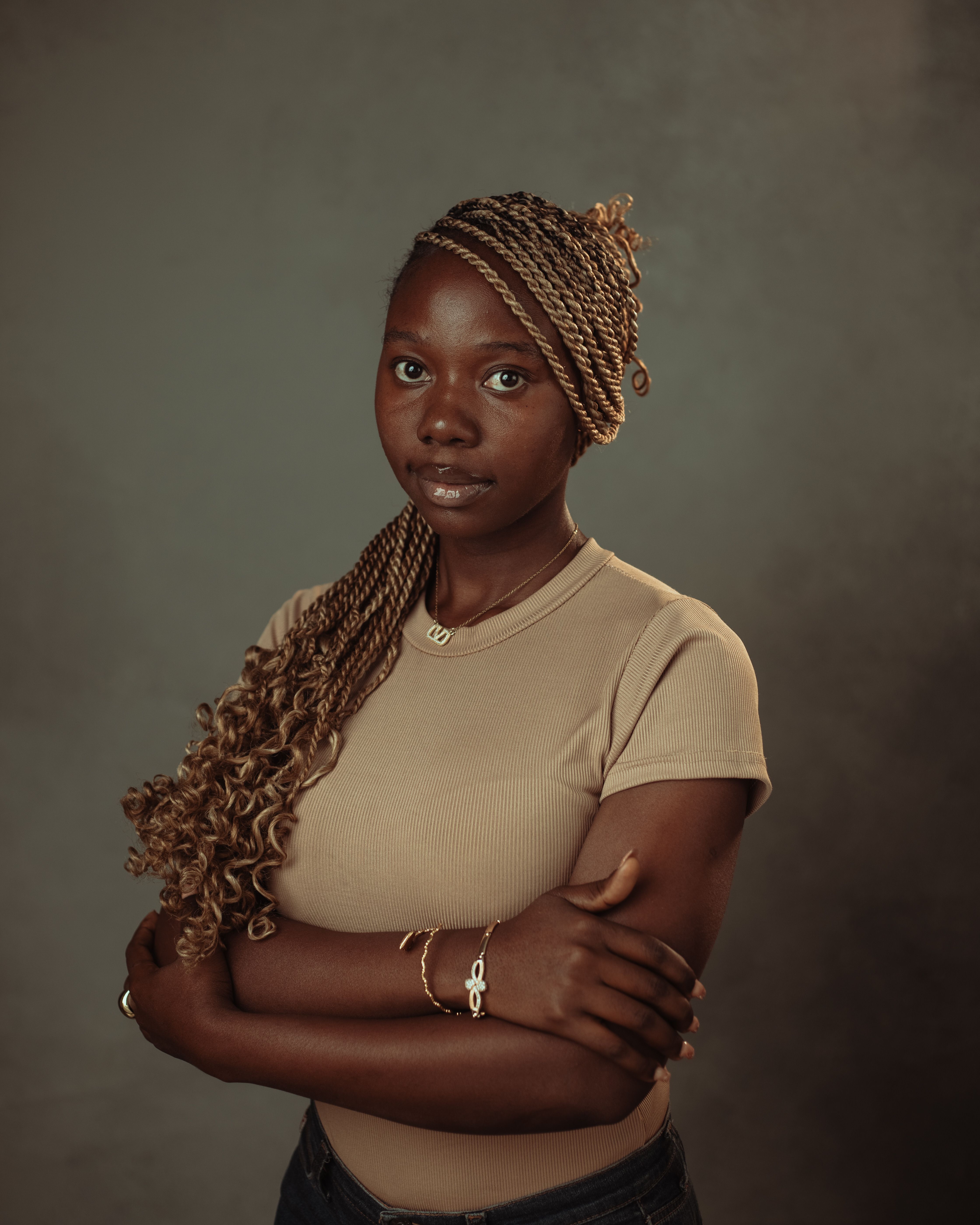 Portrait of a Woman with Braided Hair in Studio Setting · Free Stock Photo