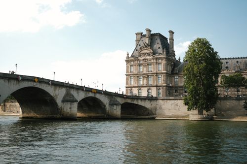 Free Scenic view of a bridge and classic architecture over the Seine River in Paris. Stock Photo