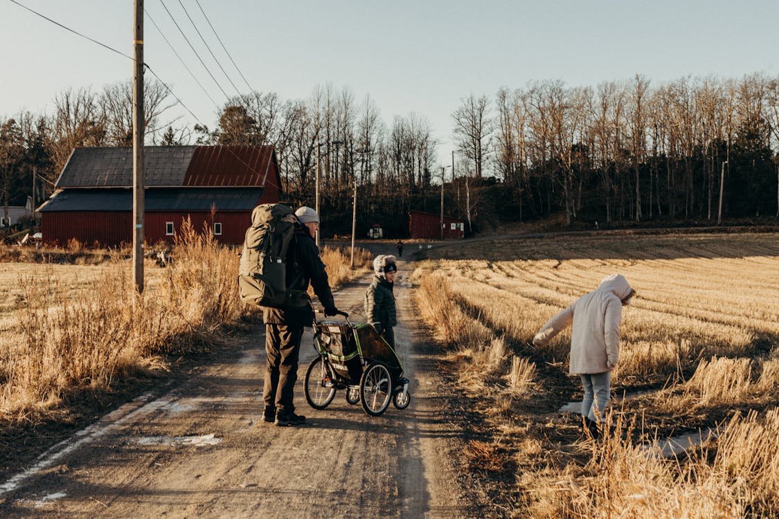 Father with Children on Dirt Road at Farm