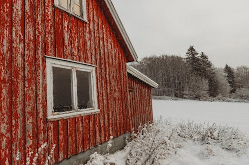 Red Wooden House on Snow Covered Ground