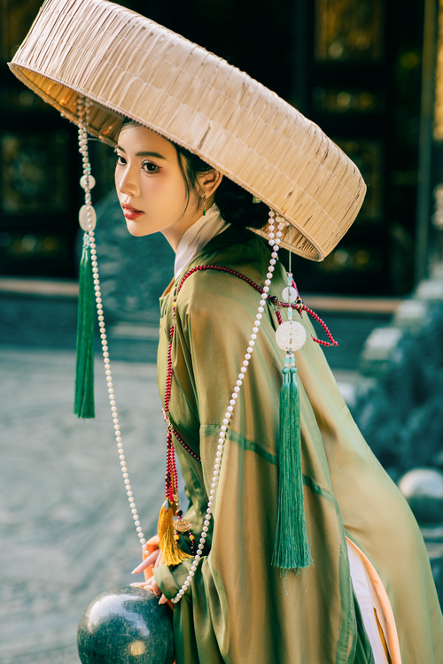 Free Portrait of a woman in traditional Asian clothing with a decorative hat. Stock Photo