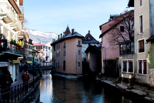 Scenic view of Annecy canal with medieval European architecture in winter.