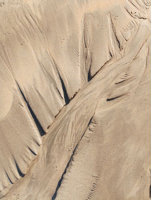 Free Intricate sand patterns on a Casablanca beach create abstract natural art. Stock Photo