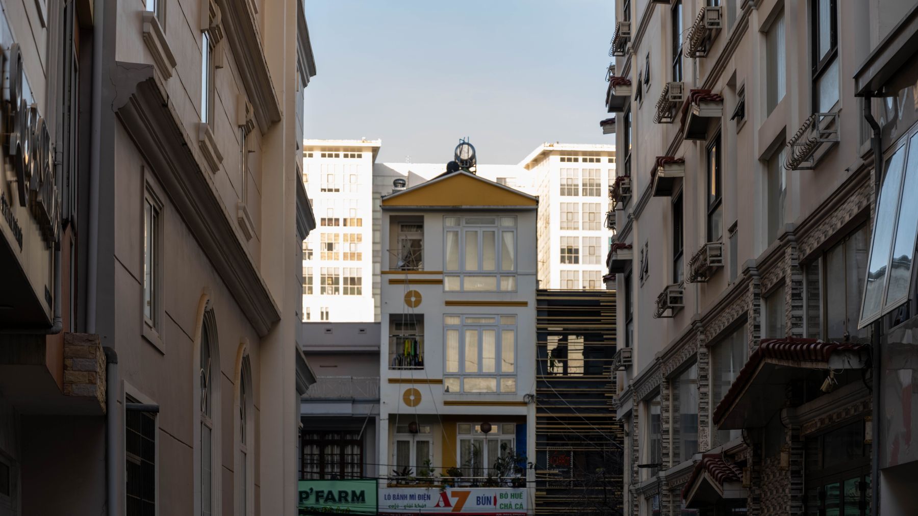 A narrow alley in Dalat with buildings showcasing classic Vietnamese urban architecture.