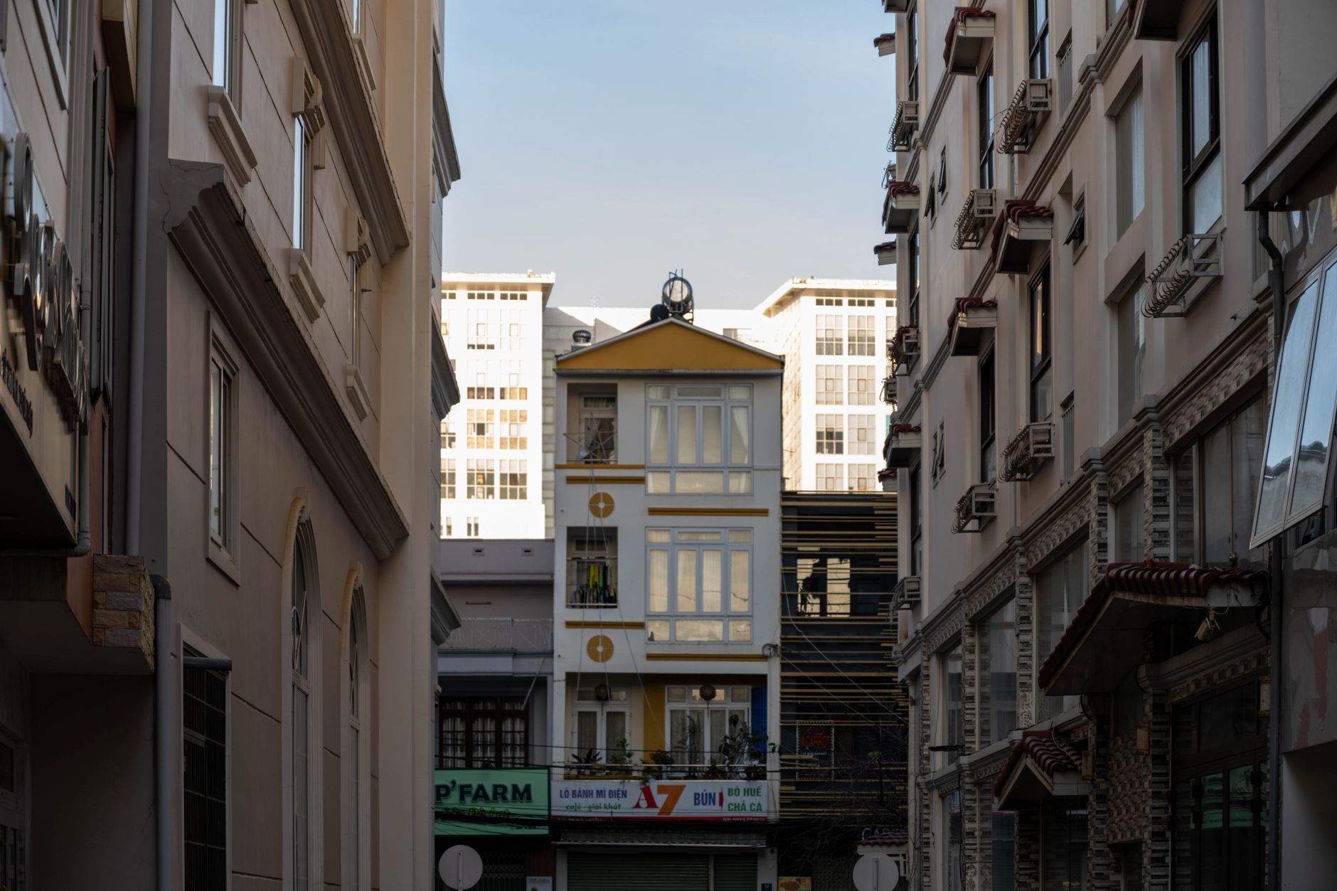 A narrow alley in Dalat with buildings showcasing classic Vietnamese urban architecture.