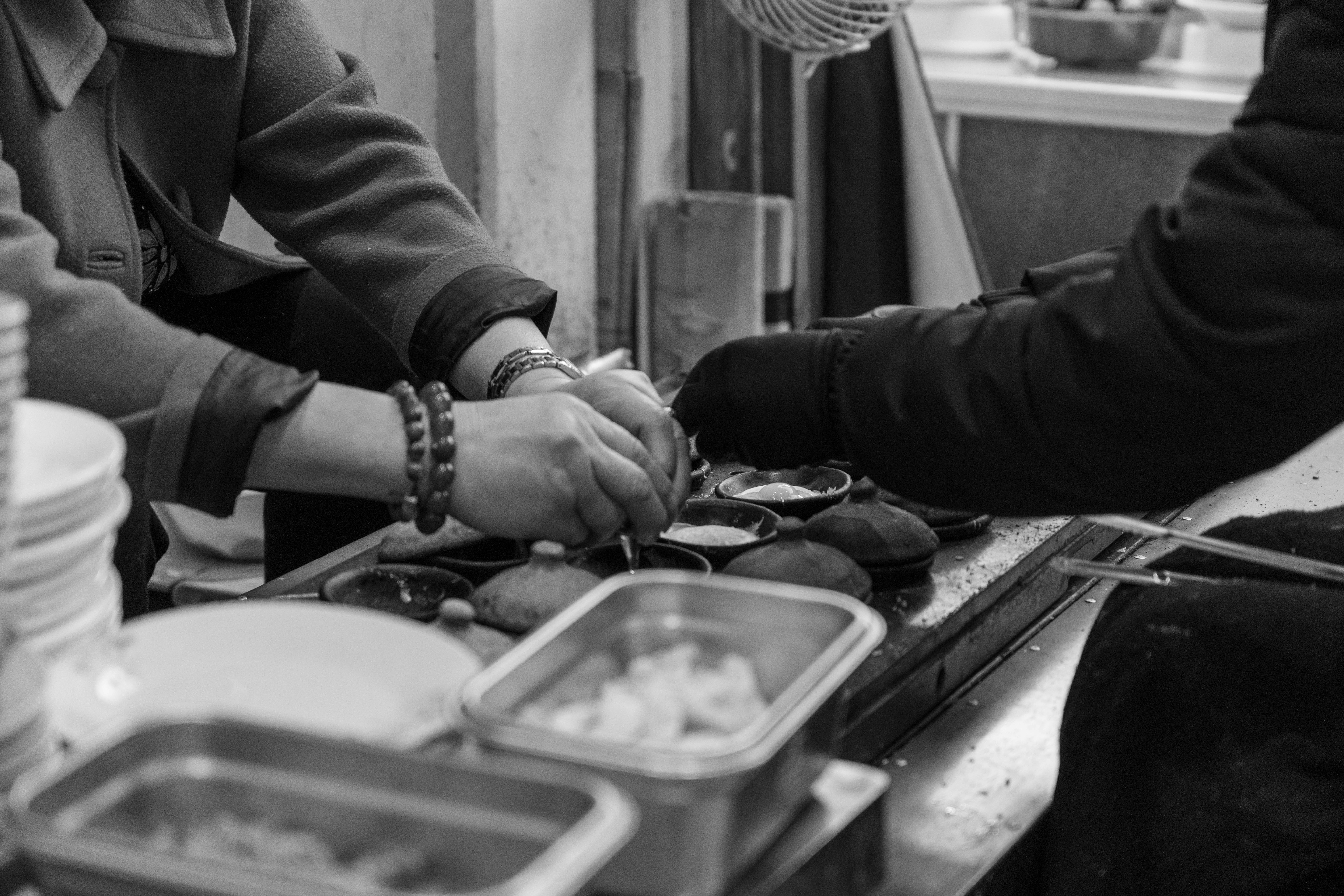 A black and white shot showcasing street food preparation in Dalat, Vietnam.