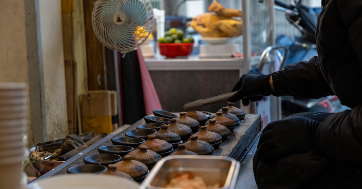 Local street food preparation at a popular stall in Xian