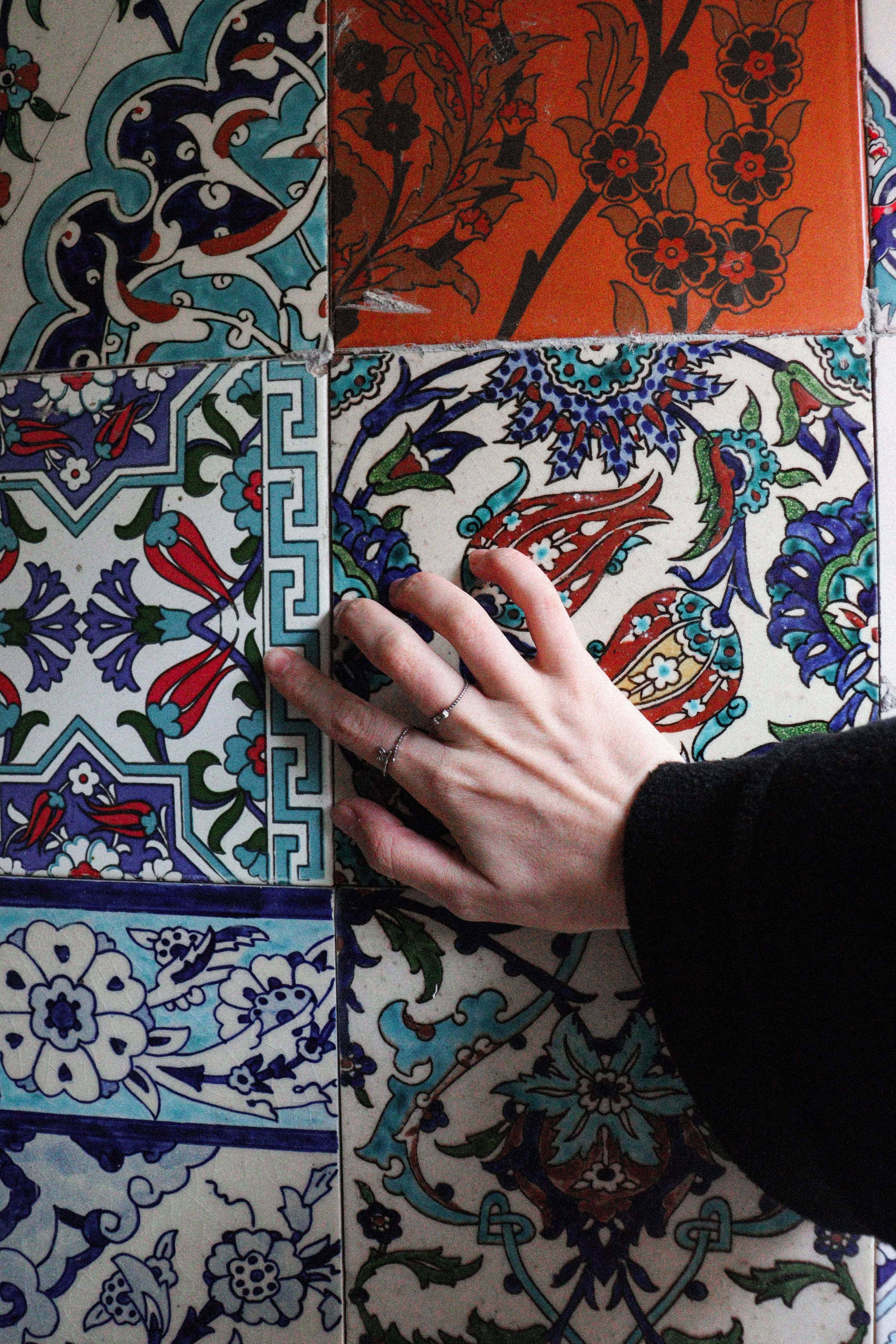 Hand Touching Ornate Ceramic Tiles · Free Stock Photo