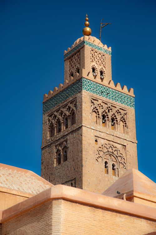 Free Majestic view of the Koutoubia Mosque Minaret against a clear blue sky in Marrakesh, Morocco. Stock Photo