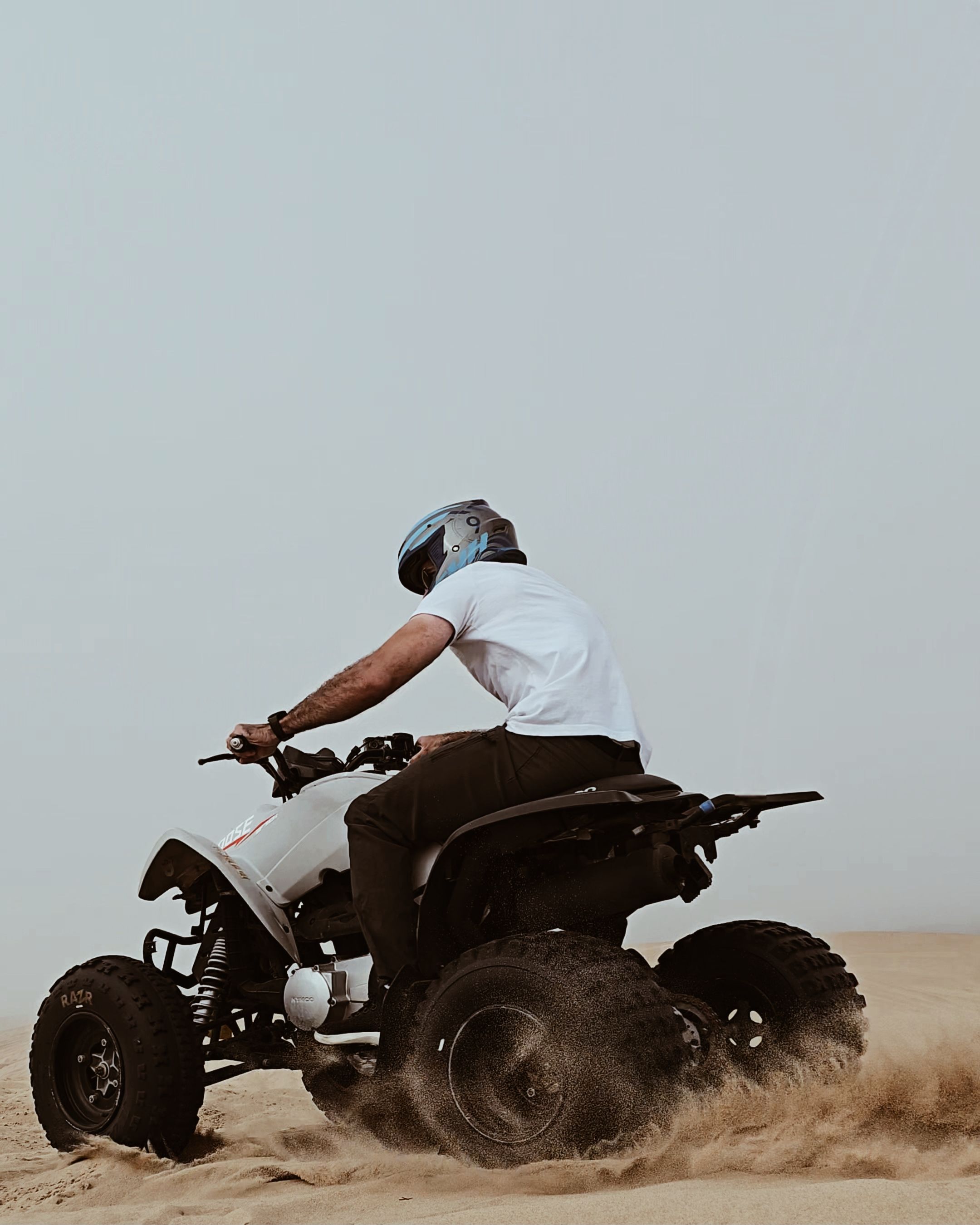 Thrilling adventure on an ATV amidst the sandy dunes of Pismo Beach, California.