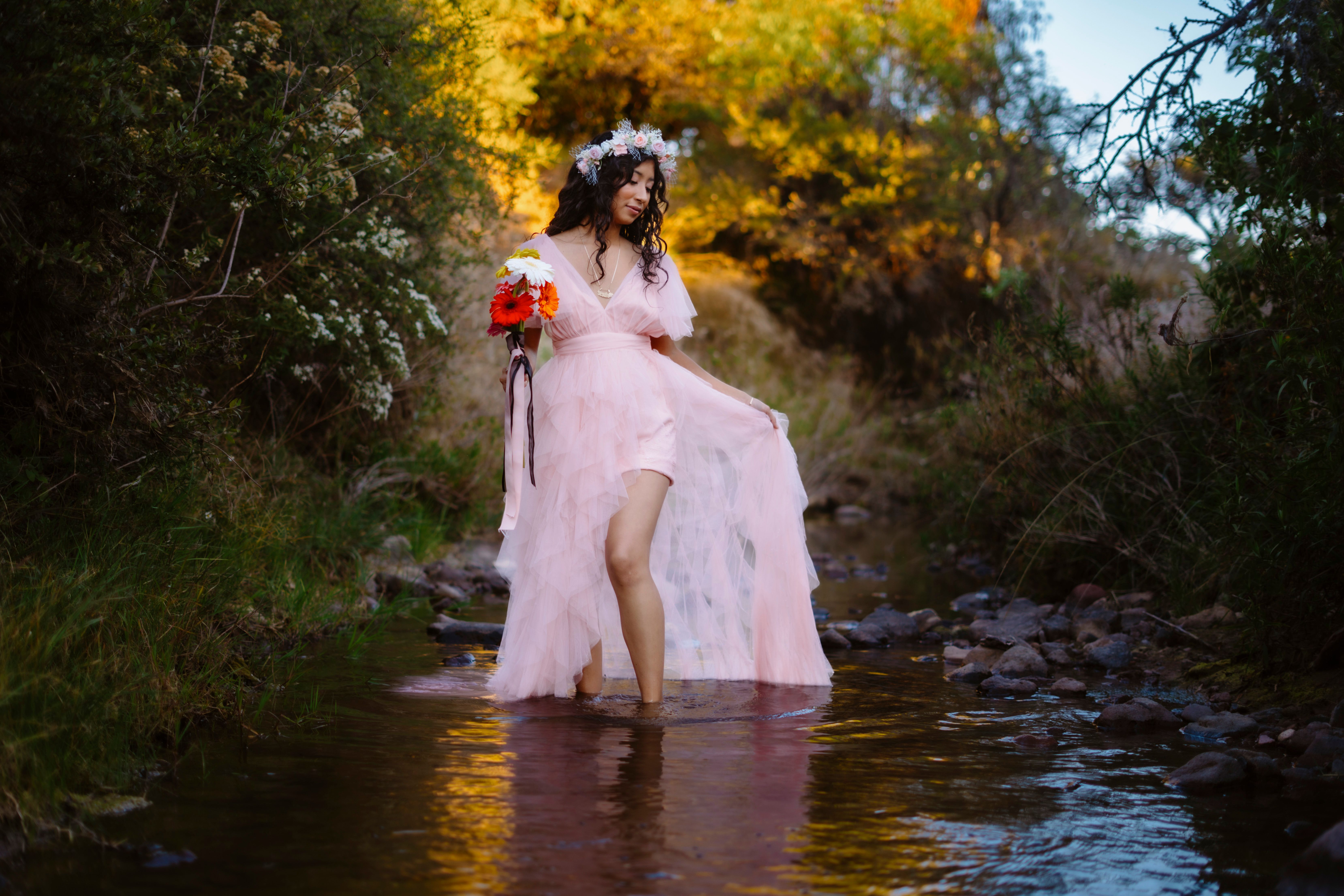 Woman in Pink Dress Standing in Scenic Stream · Free Stock Photo