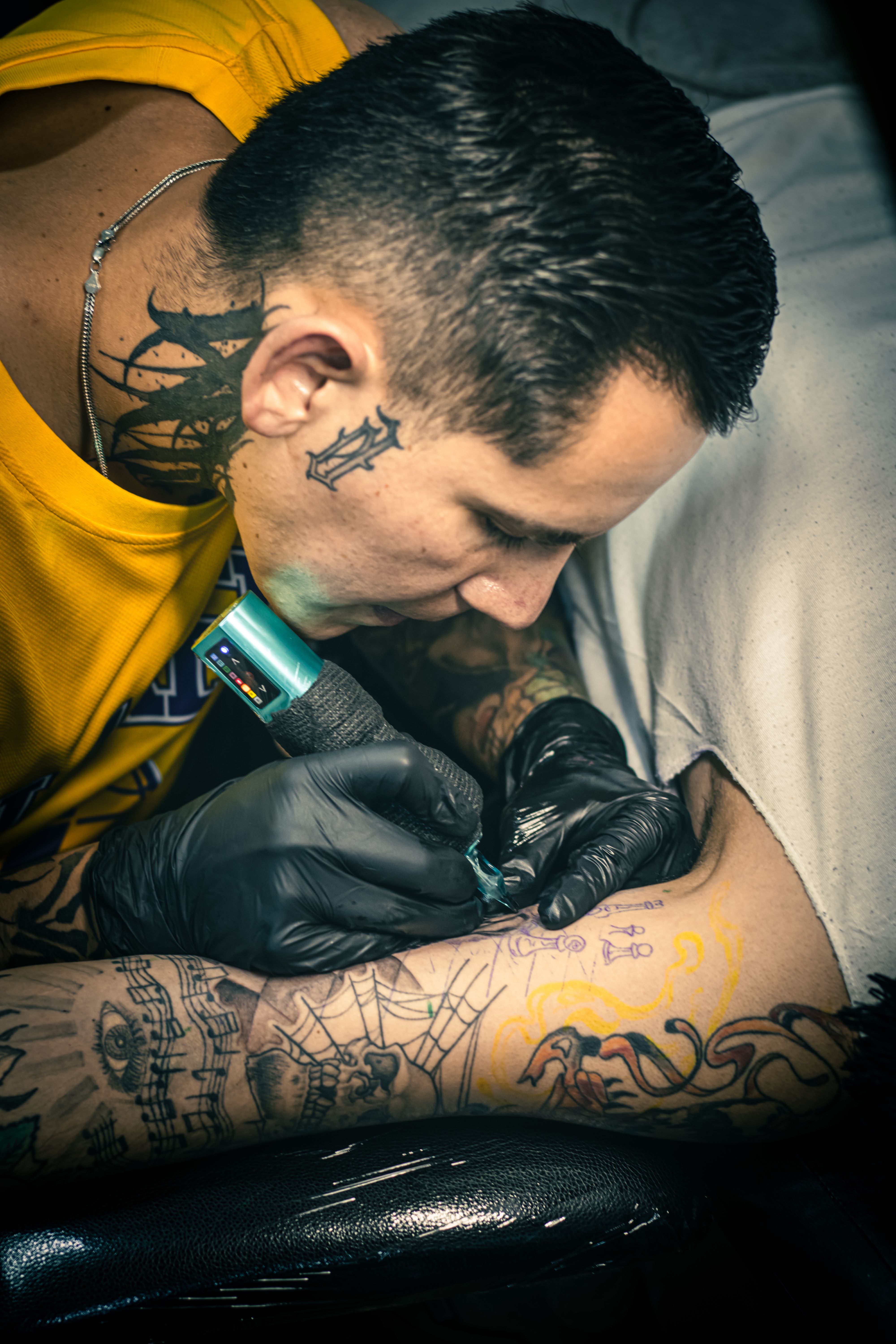 Detailed shot of a tattoo artist at work in a studio in Mexico City, showcasing tattoo culture.