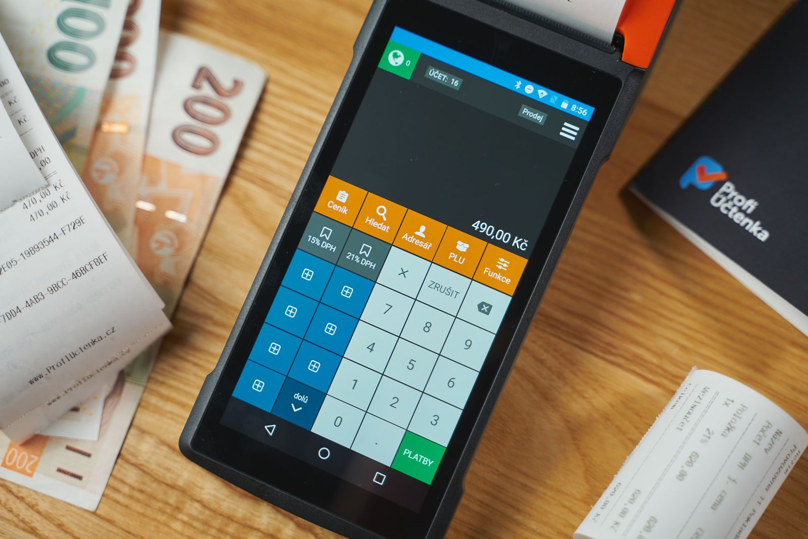 Shop checkout counter with payment terminal, receipts, and coins — tools that pay for themselves.