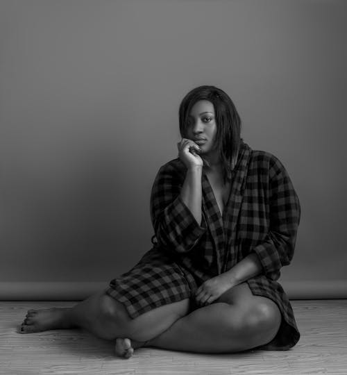 Grayscale Photography of Woman Sitting on Floor