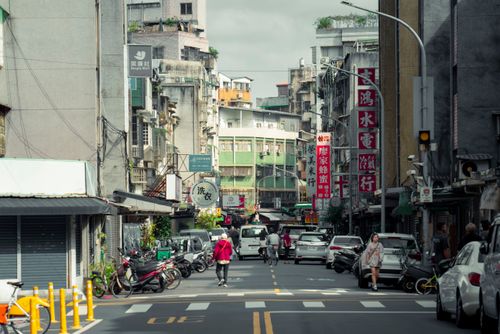 Free A vibrant city street scene in Taipei, Taiwan, with traditional shops and local traffic. Stock Photo