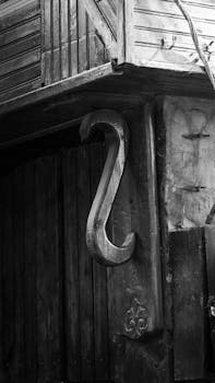 Detailed black and white image of rustic wooden architecture with vintage accents.