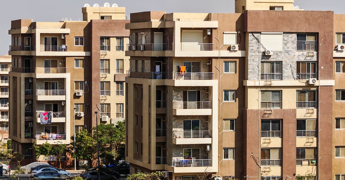 Contemporary multi-story apartment buildings in a sunny urban environment.