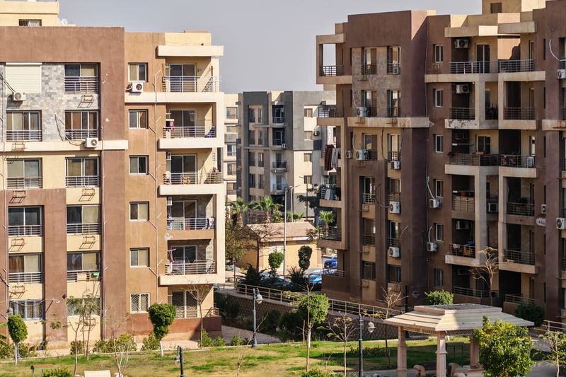 Contemporary apartment buildings with balconies and green spaces captured in daylight.