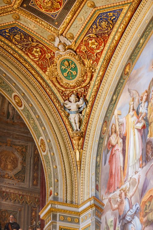 Free Colorful and ornate Roman-style archway with detailed paintings and sculptures. Stock Photo