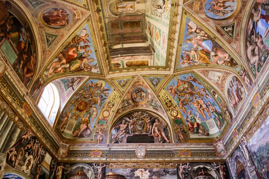 Captivating view of a Renaissance fresco-adorned vaulted ceiling, rich in detail and color.