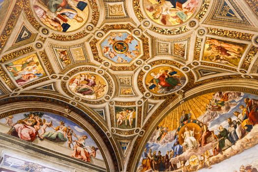 Intricately painted frescoes adorn the Vatican Museum ceilings showcasing Roman artistry.