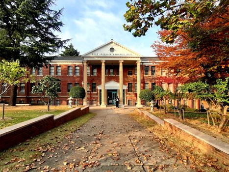A beautiful university building in Daegu, South Korea, surrounded by autumn foliage.