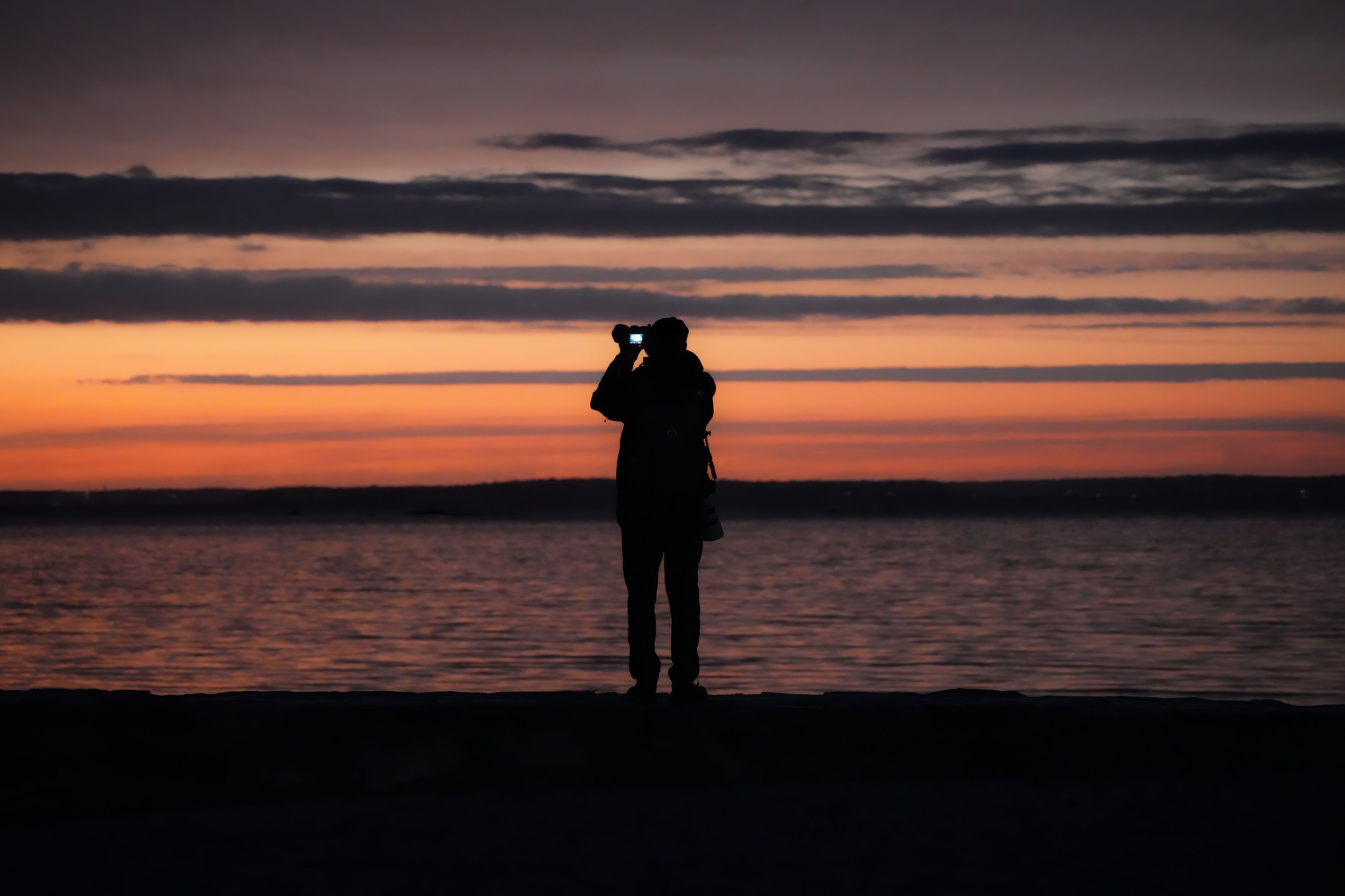 Silhouette of Photographer Capturing Sunset · Free Stock Photo