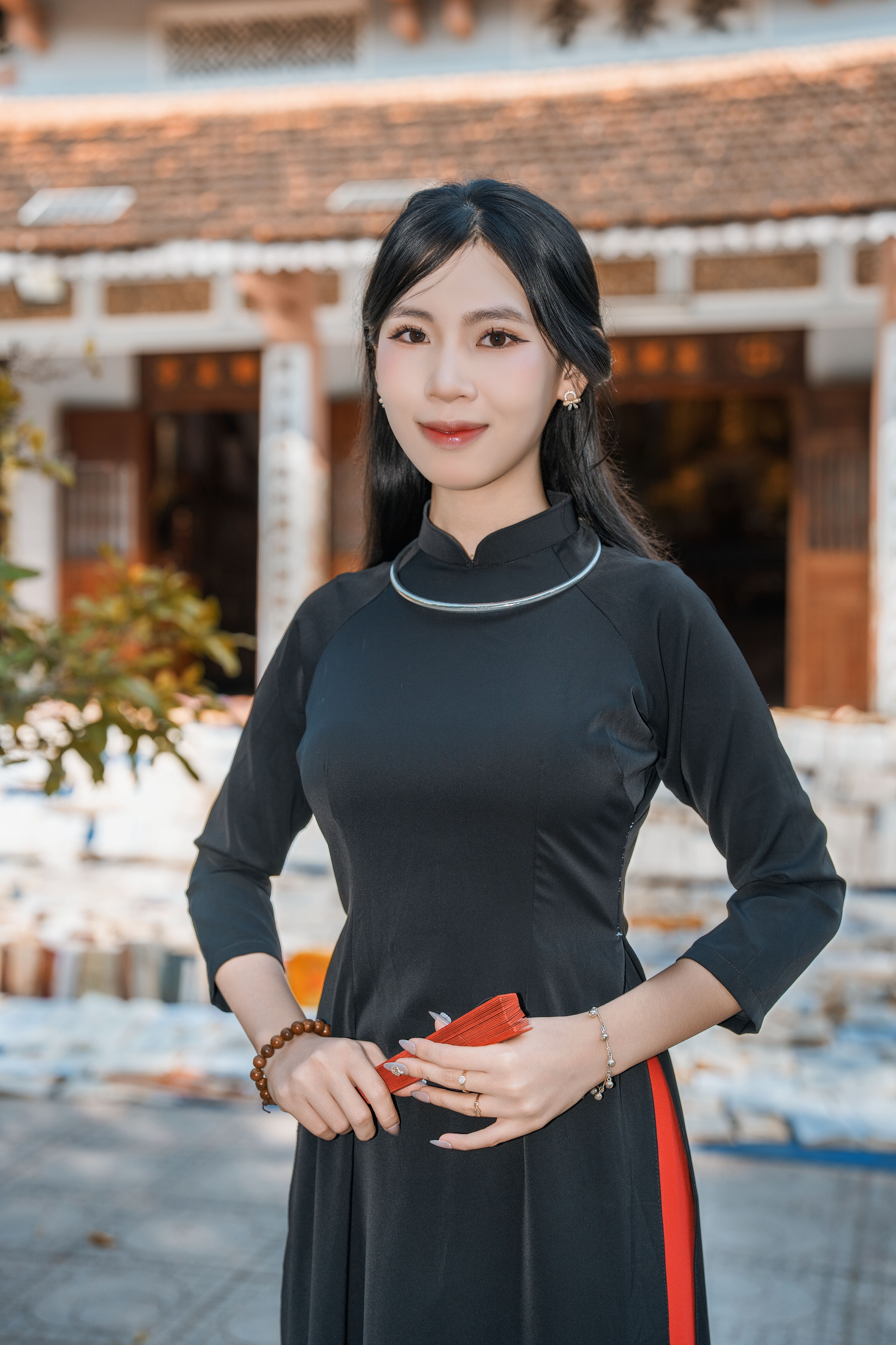 Elegant Woman Posing in Traditional Dress Outdoors · Free Stock Photo