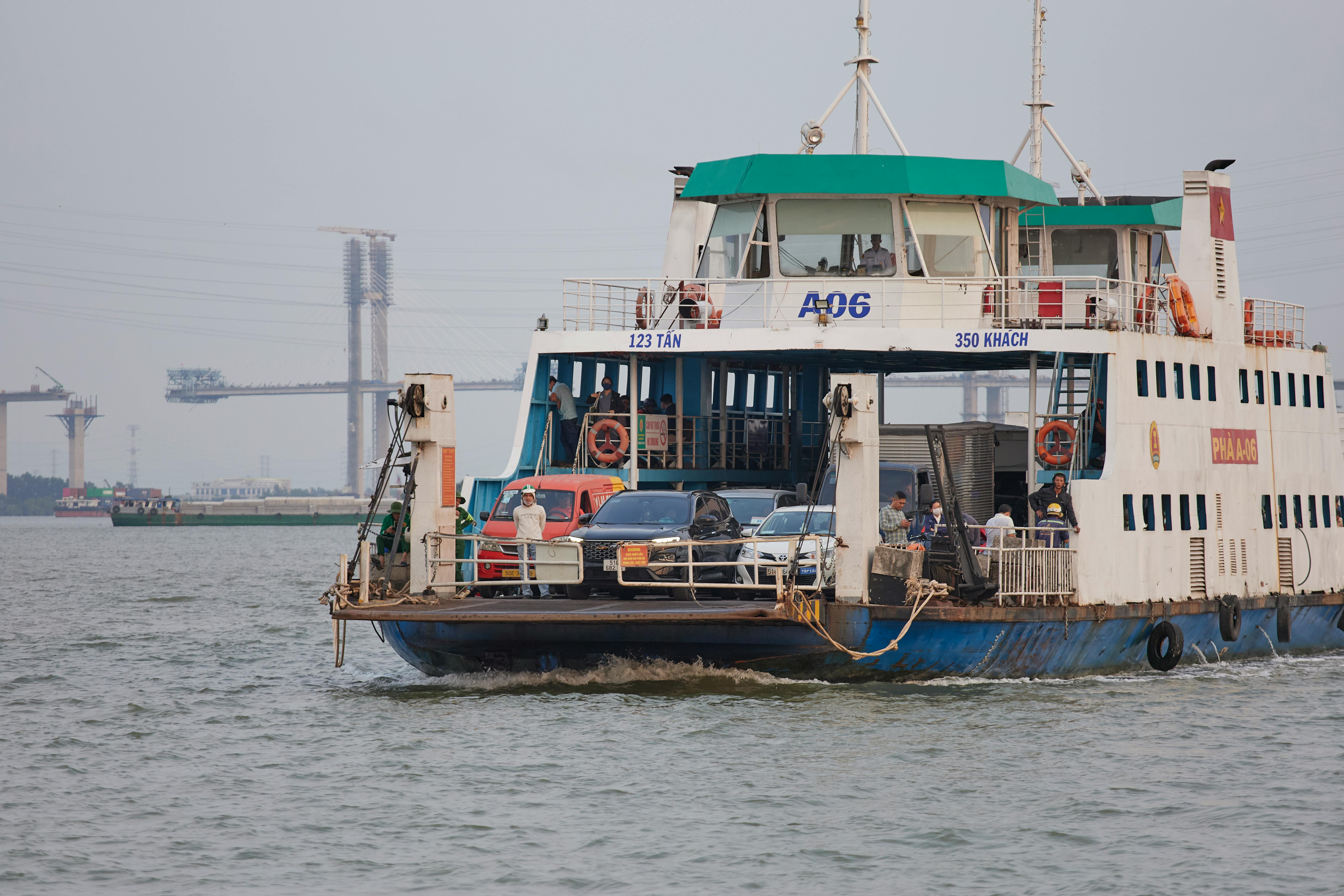 Ferry transporting people and vehicles across a river in Ho Chi Minh City, Vietnam.
