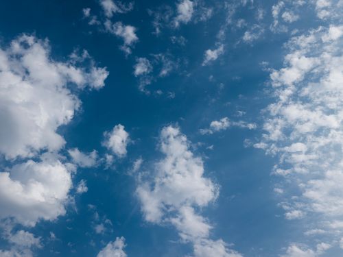 Free A peaceful blue sky filled with soft, fluffy white clouds, showcasing nature's calm beauty. Stock Photo