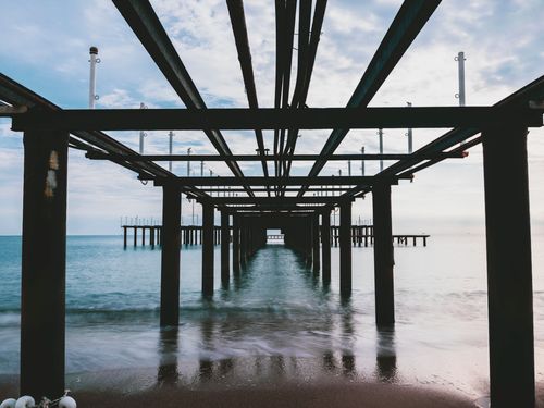Free Peaceful view of a pier extending into the ocean at dusk, perfect for relaxation. Stock Photo