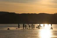 Silhouettes enjoying ice skating on a winter day in Trøndelag, Norway.