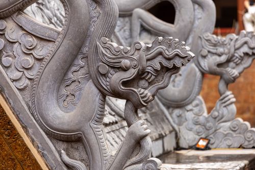 Free Detailed close-up of a traditional stone dragon sculpture from Hanoi, Vietnam. Stock Photo