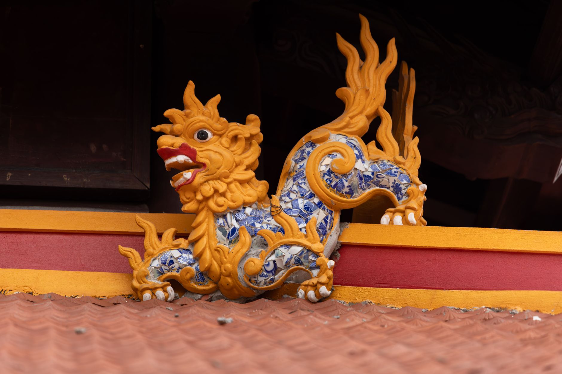 Vibrant dragon sculpture on the roof of a temple in HΓ Nα»i, Viα»t Nam.