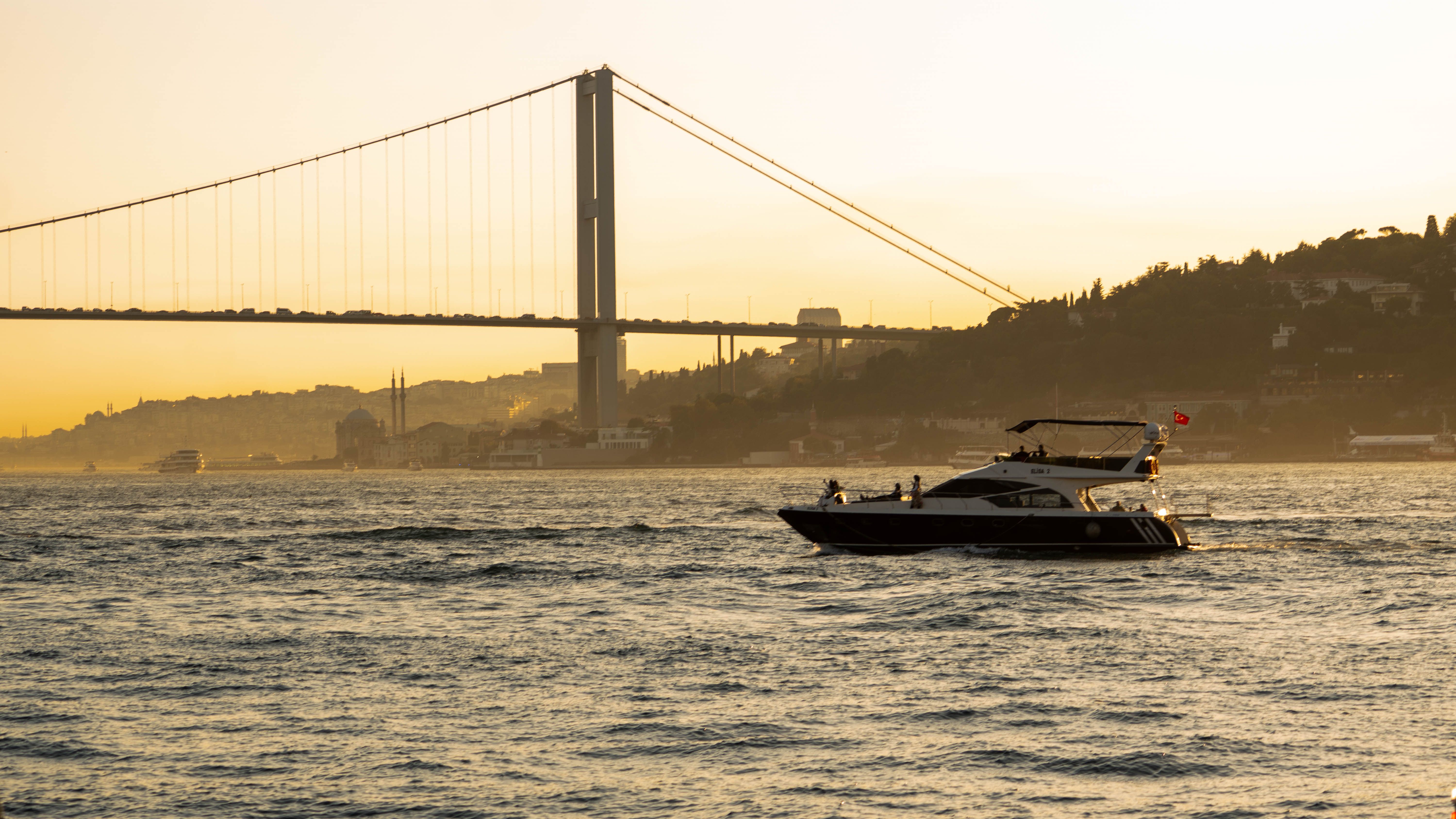 Amazing Antalya Mega Star Yacht Tour with Lunch, Foam Party & Transfer Review 2026 - Yacht sailing on the Bosphorus with the iconic bridge at sunset in Istanbul.