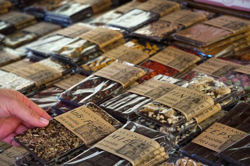 Free Close-up of artisan chocolate bars selection in a Spanish market. Perfect for gourmet product features. Stock Photo