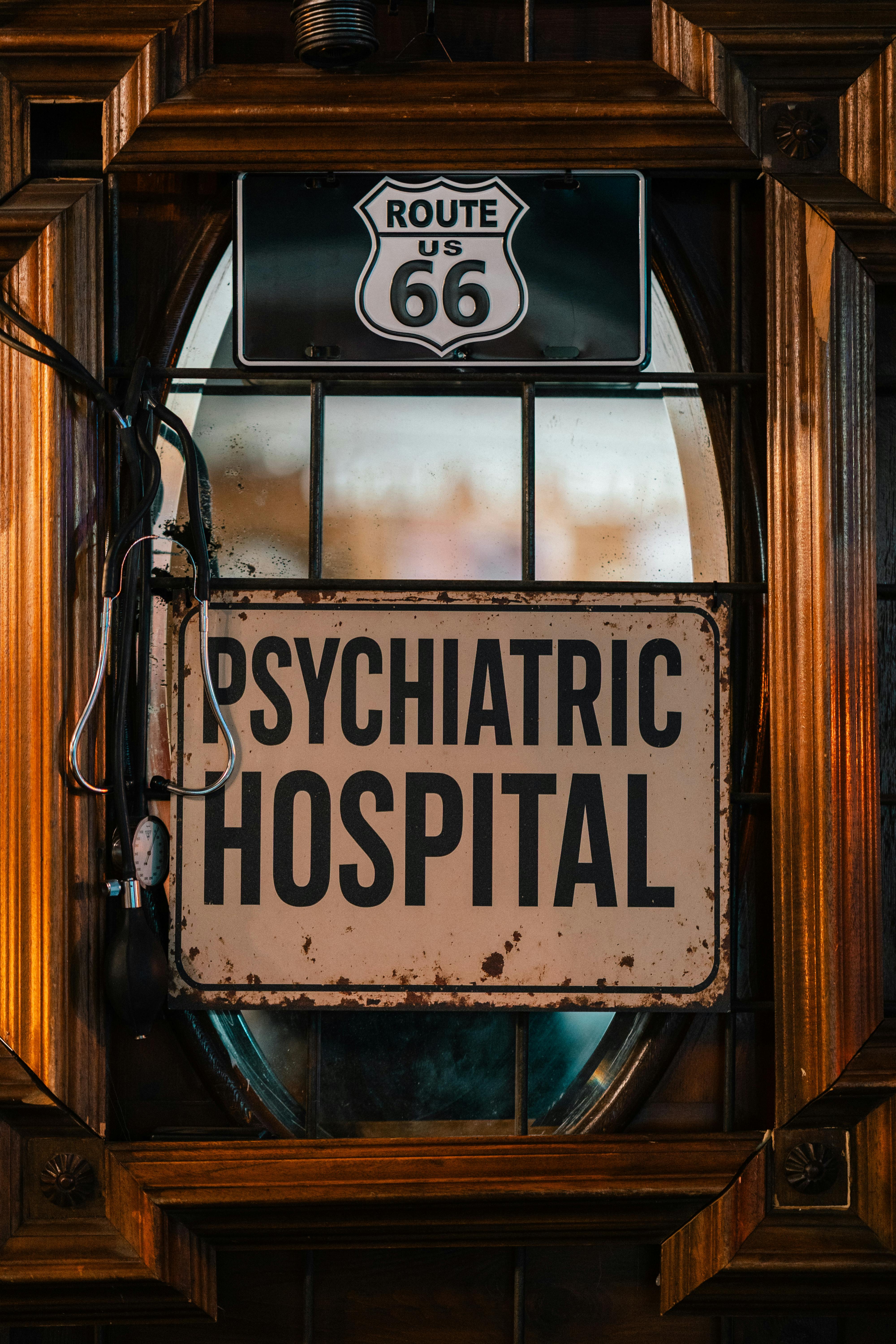 Rustic sign for Psychiatric Hospital on iconic Route 66, captured with vintage charm.