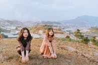 两名穿着时髦的妇女在户外以令人惊叹的乡村背景摆出姿势