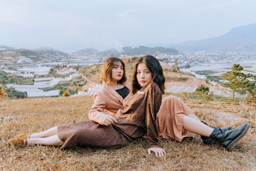 Free Two Women Sitting on Hill Stock Photo
