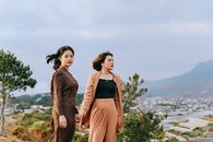 Two Women Standing on Hill