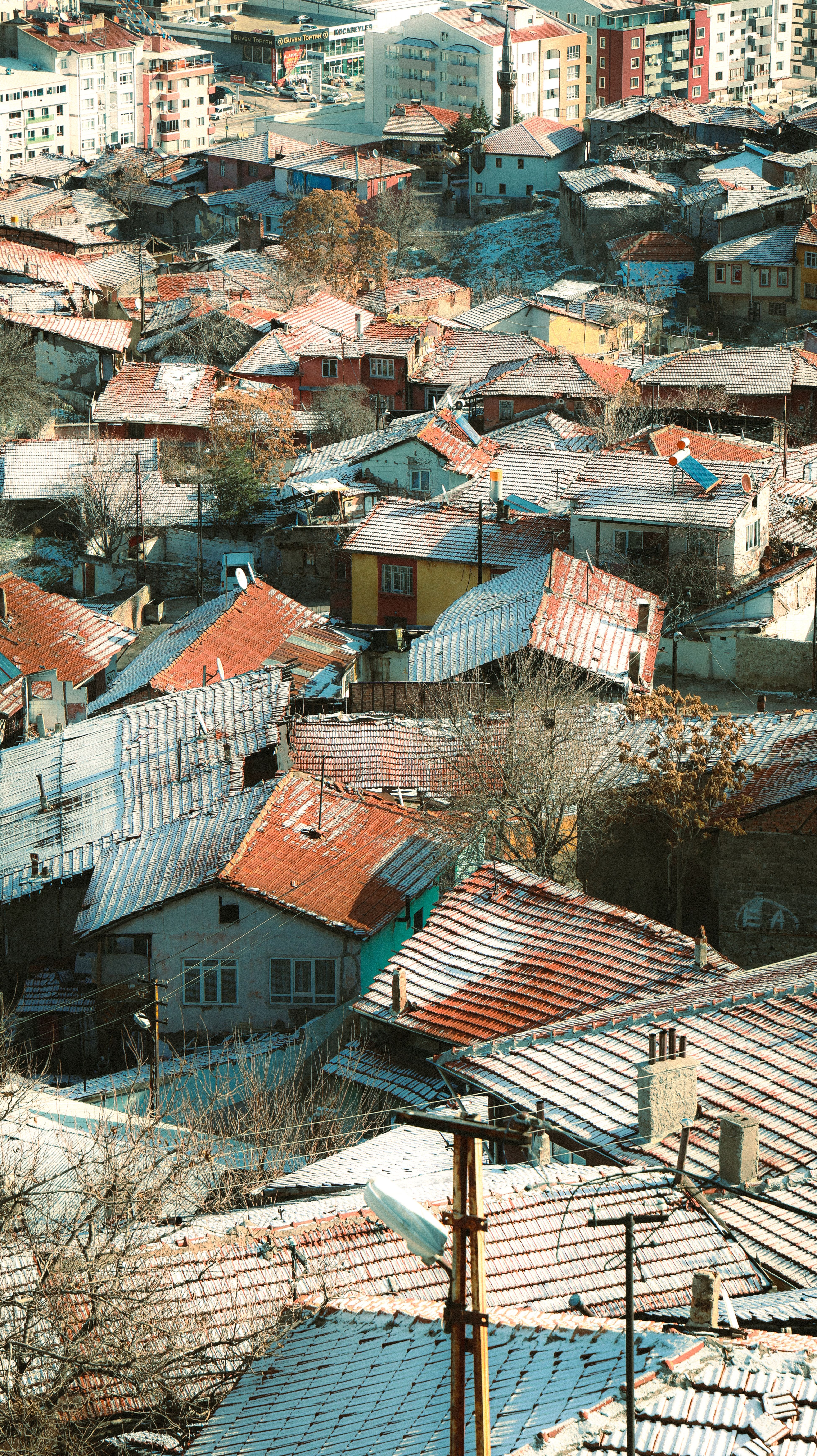 Aerial View of Snow-Covered Urban Rooftops · Free Stock Photo