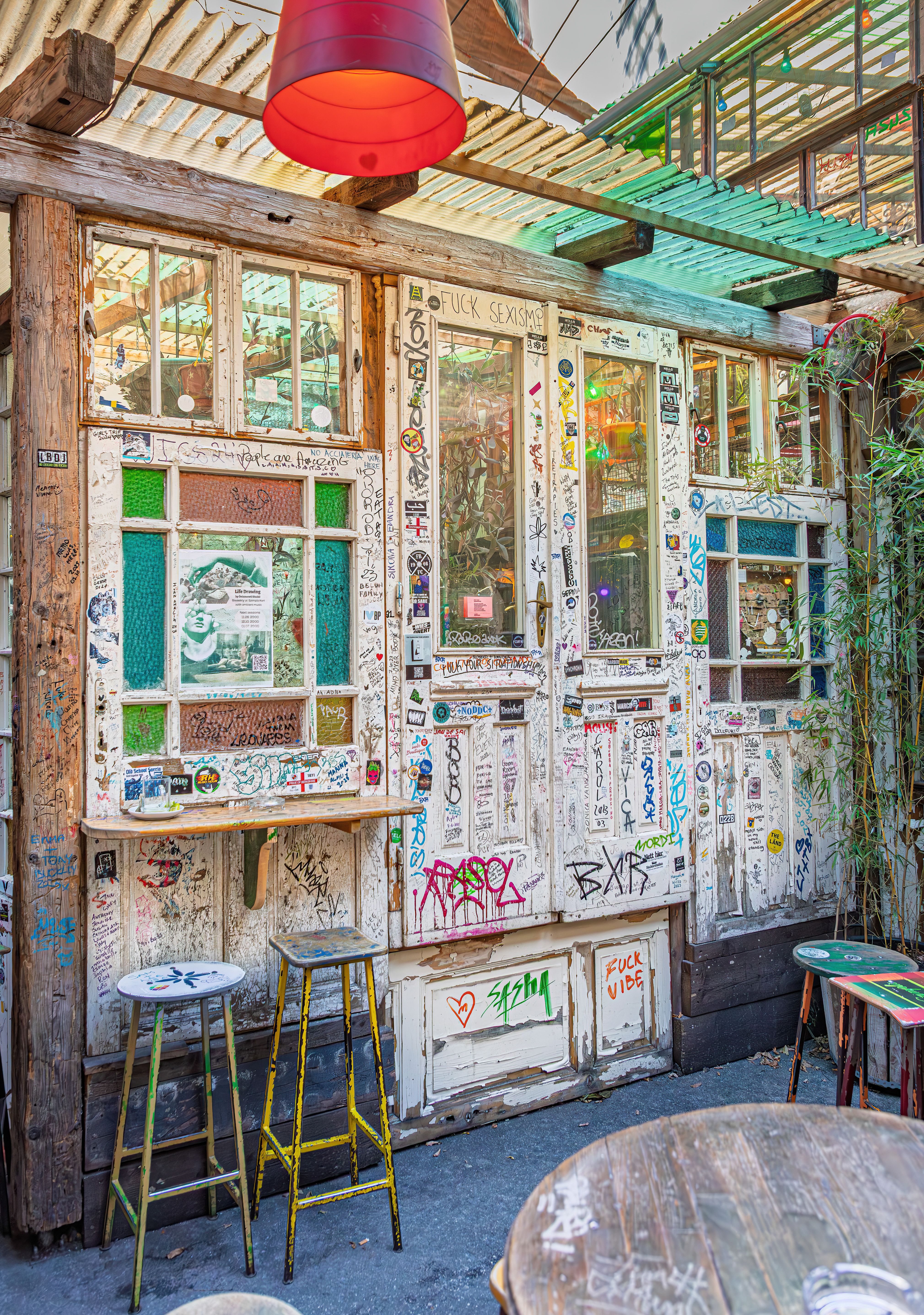 Explore a colorful and artistic ruin bar in Budapest with vibrant graffiti and rustic charm.