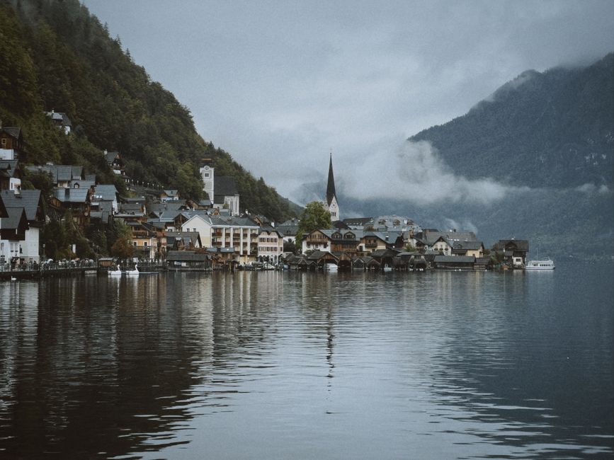 Ferry crossing Lake Hallstatt with the iconic village and mountains in the background, Austria