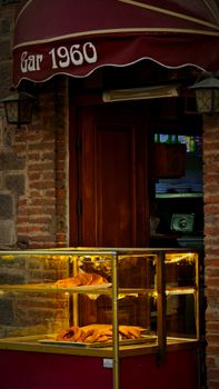 A charming bakery shopfront displaying freshly baked pastries in a warm setting.
