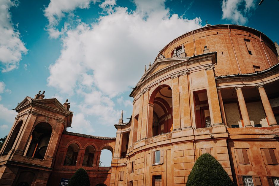 Stunning view of a historic architectural structure with dramatic clouds and vibrant blue sky.