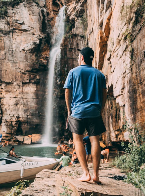 Free Man Looking At A Waterfalls Stock Photo