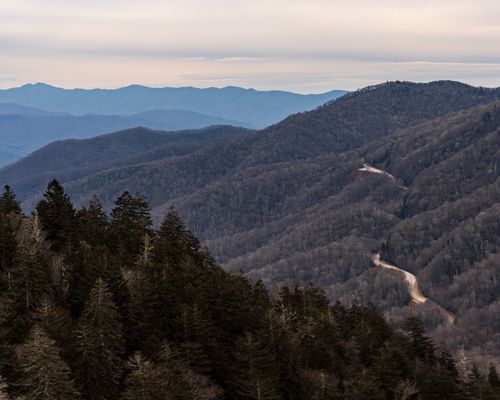 Free A captivating view of the Smoky Mountains with winding road, showcasing the serene winter landscape. Stock Photo