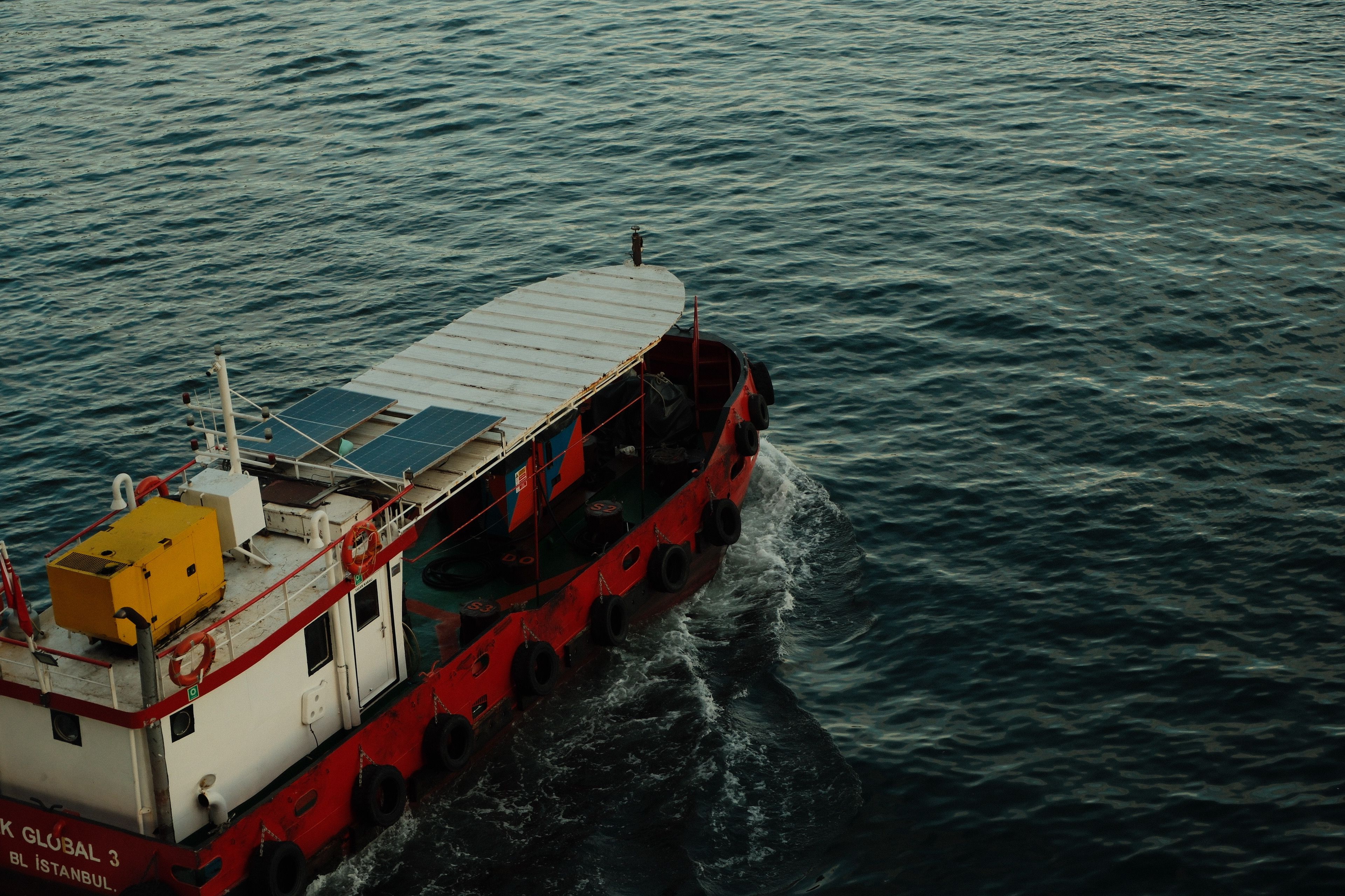 Red Tugboat Sailing in Open Sea at Daytime · Free Stock Photo